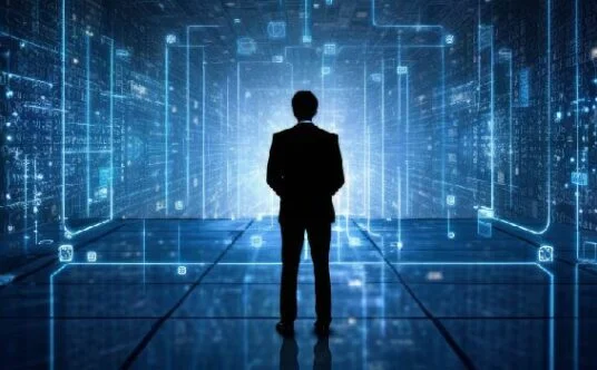 Silhouette of a businessperson in a suit standing in a glowing blue digital data tunnel.